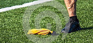 Yellow penelty flag on the field next to an officials foot