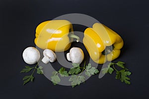 Yellow pepper with mushrooms and herbs on a dark background.