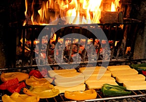 Yellow peppers grilled in a fireplace