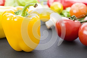 Yellow peppers on the table. Yellow peppers are on the old table. Dietary food. Yellow peppers on a table on a background of veget