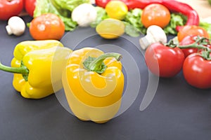 Yellow peppers on the table. Yellow peppers are on the old table. Dietary food. Yellow peppers on a table on a background of veget