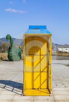 Yellow phone booth in the park