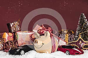 Yellow pig with a red bow, miniature cars, presents