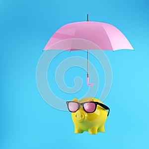 Yellow Piggy savings with protection by pink umbrella on blue background.minimal concept