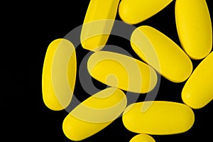 Yellow Pills on Black Background