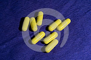 Yellow pills on blue background