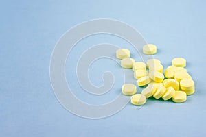Yellow pills on a blue background.