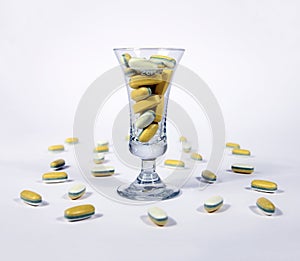 Yellow pills in a glass photo