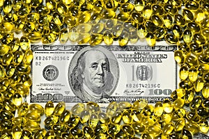 Yellow pills and one hundred dollars banknote