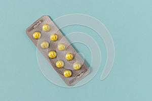 Yellow pills with question mark on blue