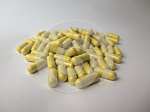 The mountain of pills on white background, yellow pills, vitamin