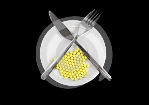 Yellow pills-vitamins ,with fork and spoon