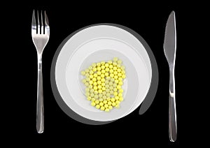 Yellow pills-vitamins ,with fork and spoon