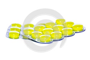 Yellow pills on white background