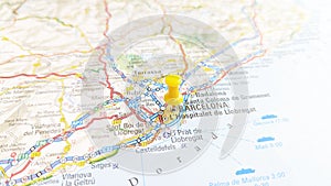 A yellow pin stuck in Barcelona on a map of Spain photo