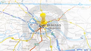 A yellow pin stuck in Belgrade on a map of Serbia