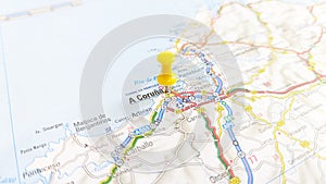 A yellow pin stuck in A Coruna on a map of Spain photo