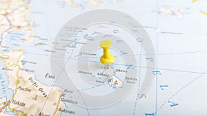 A yellow pin stuck in the island of skyros skiros on a map of Greece