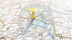 A yellow pin stuck in luzern Lucerne on a map of Switzerland