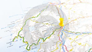 A yellow pin stuck in Santiago de Compostela on a map of Spain photo