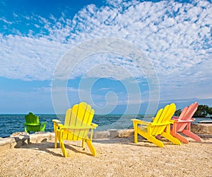 Yellow and pink colorful lounge chairs on a beach in Florida