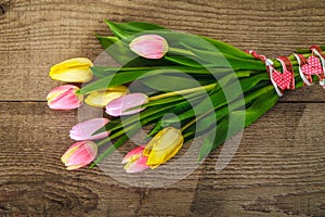 Yellow and pink tulips on the wood