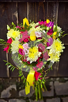 Yellow and pink wedding bouquet on a dark background