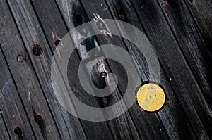 A yellow pipe cap on the wooden deck of a battleship.