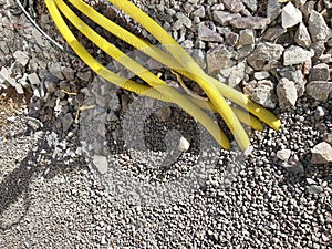Yellow pipes for electric cables or water sticking from the ground at construction site