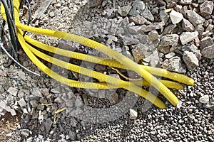 Yellow pipes for electric cables or water sticking from the ground at construction site