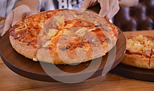 Yellow pizza on a tray, looks good, is popular to eat