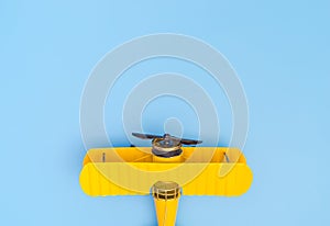 Yellow plane on blue copy space on the top for travel concept