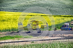 A Yellow plane by the yellow field