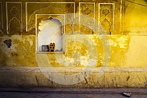 Yellow plaster and offering shrine, India, Jaipur