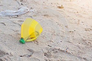 Yellow Plastic bottle on Beach Pollution Environment