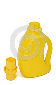 Yellow plastic bottle with a dispenser in cap, isolated on white