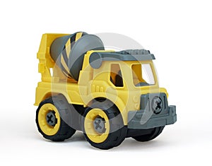 Yellow plastic cement mixer truck toy isolated on white background.