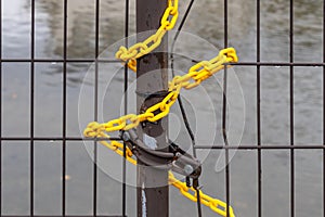 Yellow plastic chain on metal gate, Kanazawa, Japan