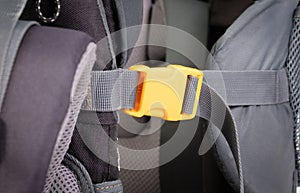 Yellow plastic clasp of backpack