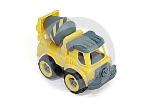 Yellow plastic concrete mixer truck toy isolated on white background.