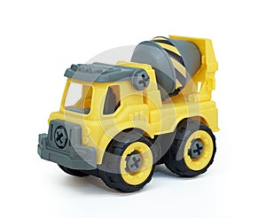 Yellow plastic concrete mixer truck toy isolated on white background.