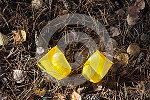 Yellow plastic cups on the ground