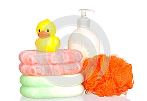 Yellow plastic duck over sponges and boat bath dis