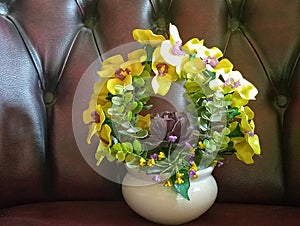 yellow plastic flowers on a black sofa