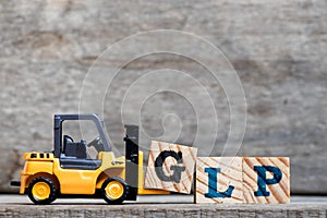 Yellow plastic forklift hold letter G to complete word GLP