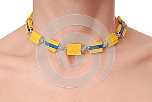 Yellow plastic necklace on female neck