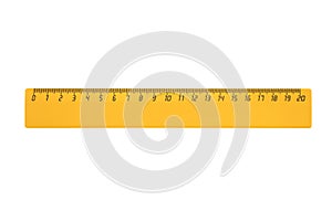 Yellow plastic ruler 20 centimeters long is isolated on a white background