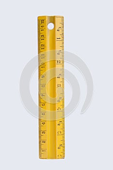 Yellow plastic ruler isolated on white background.