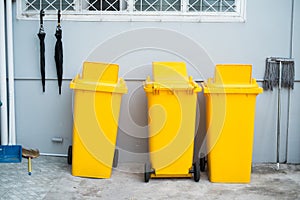 Yellow plastic trashbin