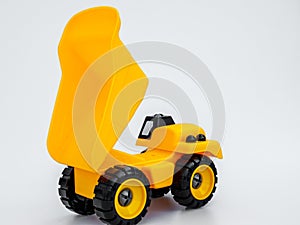 Yellow plastic truck toy isolated white